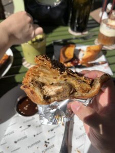 chicken curry pie with cross section, revealing a chunk of chicken and heaps of layers of pastry