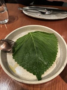 raw tuna tabbouleh served below a leaf