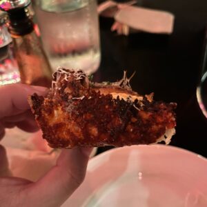 city oltra sausage and potato pizza with a charred, crispy corner